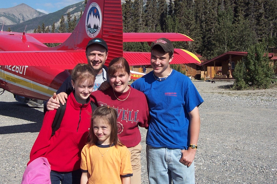 family beside bush plane